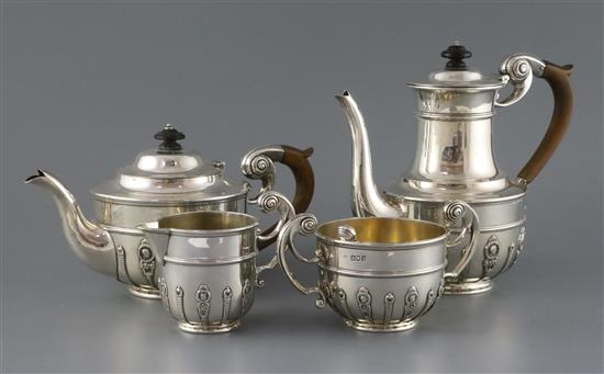 An Edwardian silver four-piece tea and coffee set, rounded body with medallion heads, scroll handles,